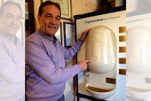 Photo of Luciano Marabese and his holy water dispenser